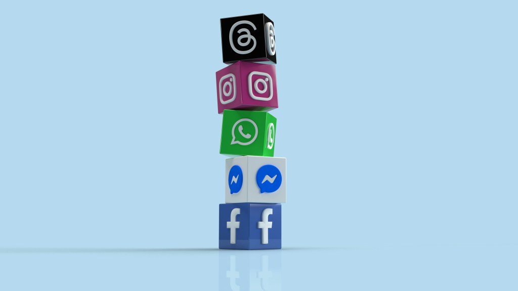 A stack of blocks against a blue background. Each block shows the icon of a social media app--threads, instagram, whatsapp. messenger, facebook.